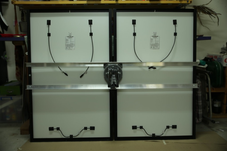 The rear of two photovoltaic modules, wired together before mounting